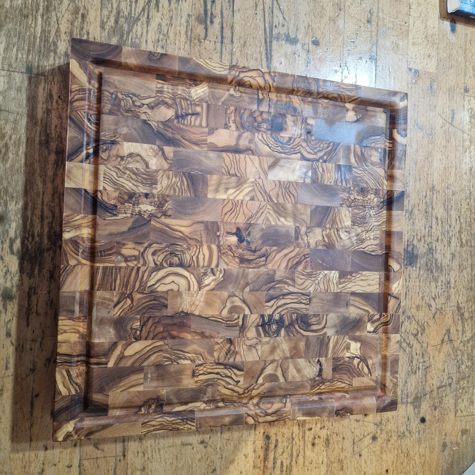 End-grain olive wood cutting board seen from above