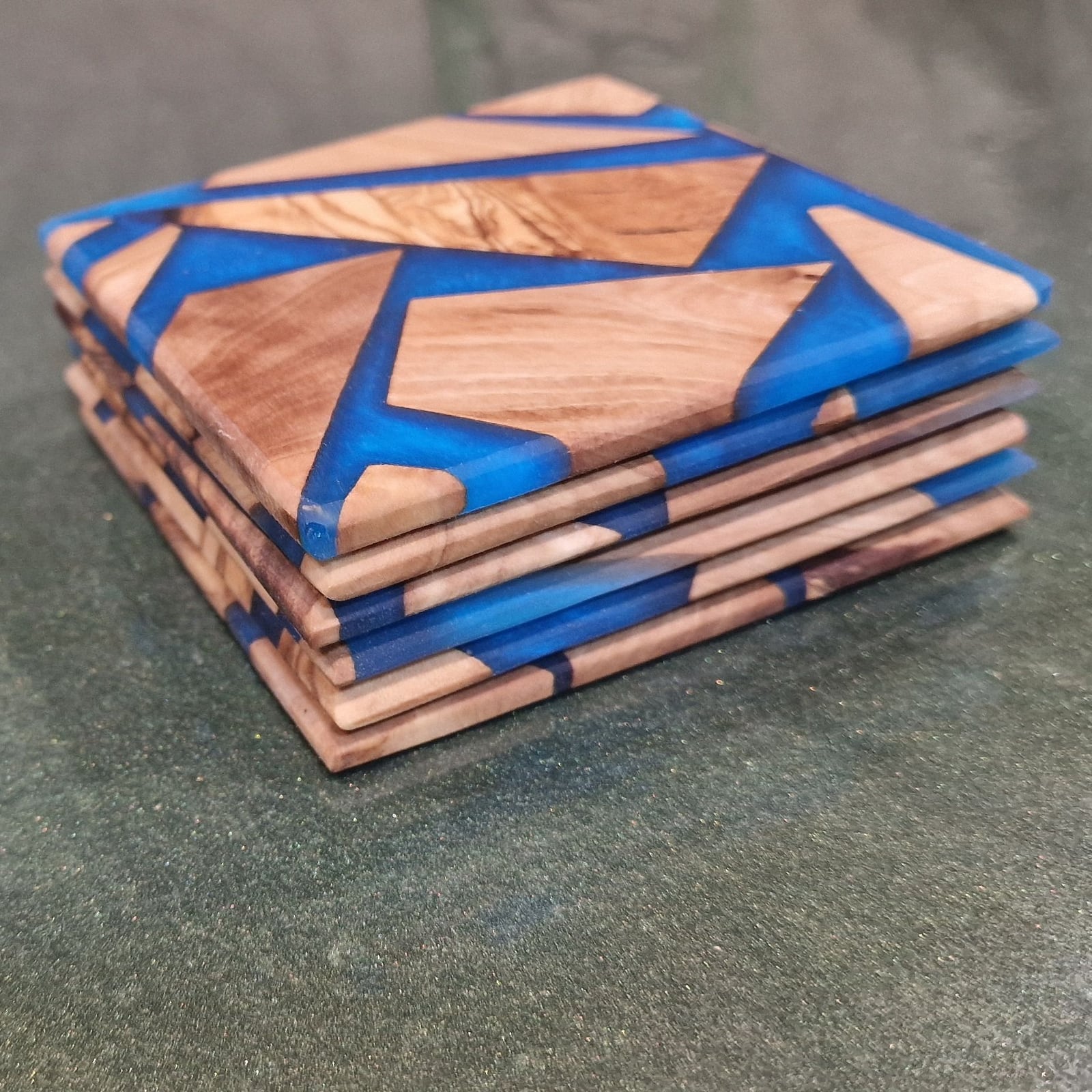Stack of olive wood and blue resin coasters